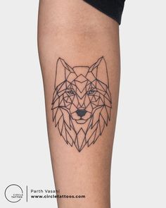 a black and white tattoo of a wolf on the leg