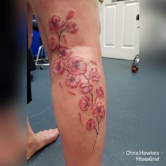 a woman's leg with pink flowers on it