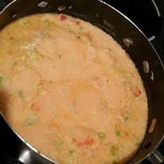 a pan filled with food sitting on top of a stove