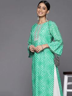 This is a single piece kurta. It comes with straight shape kurta comes with floral print detailing has round neck, 3/4th sleeves & calf length. Single Piece Color-Green Suit Fabric-Cotton Work - Leheriya Print & Gota Patti Detailing Neck-Round Neck Sleeves-3/4th Flared Sleeves Kurta Length - Calf Length Washing Care - Hand Wash Size worn by the model: Small Height: 5'7" Green Suit, Suit Fabric, Green Cotton, Indian Wear, Straight Cut, Flared Sleeves, Single Piece, Fabric Cotton, Indian Fashion