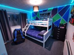 a bedroom with a bunk bed and blue lights on the ceiling is decorated in black and white