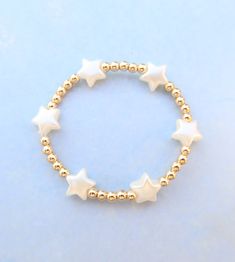 pearl star 14k fill beaded bracelet Adjustable Star Shaped Jewelry With Spacer Beads, Adjustable Star-shaped Jewelry With Spacer Beads, Adjustable Dainty Star Jewelry, White Jewelry With Star Charm And Round Beads, White Star-shaped Handmade Jewelry, Handmade White Star Jewelry, Pearl Jewelry With Star Charm As A Gift, Star-shaped Pearl Jewelry For Gift, Pearl Jewelry With Star Charm For Gift