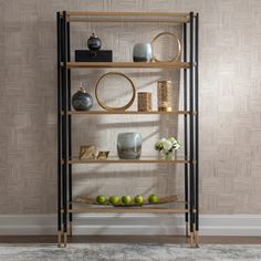 a shelf with vases and other items on it in front of a wallpapered background