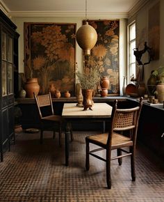 a dining room table with chairs and vases on it