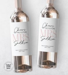 two bottles of wine with the names of their wedding guests and date printed on them