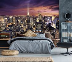 a bedroom with a large city skyline wall mural in the background and a bed on top of it