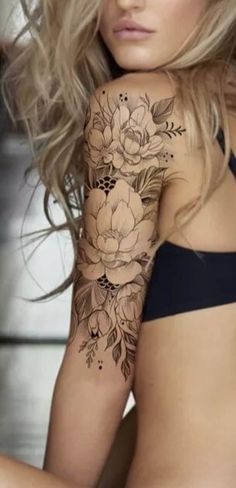 a woman with a flower tattoo on her arm