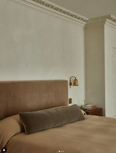 a large bed sitting next to a window in a bedroom