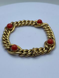 18ky gold Carlo Weingrill Verona Coral Bracelet 34.2g 8 inches. This item is on consignment and sold as-is.  A beautiful statement piece designed by Carlo Weingrill. A station bracelet crafted in 18ky gold with 4 cabochon coral. 2nd coral from tongue clasp appears to have been replaced. Widest section is 14mm and chain link section is 9.6mm. The wear is consistent with its age and use. Luxury Red Coral Jewelry, Luxury Coral Jewelry For Formal Occasions, Luxury Red Round Gold Bracelet, Luxury Red Coral Jewelry For Formal Occasions, Formal Yellow Gold Jewelry With Red Coral, Station Bracelet, Coral Bracelet, Jacksonville Fl, Bracelet Crafts