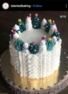 a cake decorated with snowmen and christmas trees