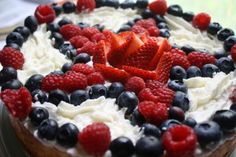 an american flag cake with berries and blueberries on top