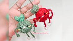 two crocheted keychains shaped like animals are being held by someone's hand