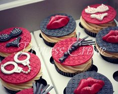 cupcakes decorated with red, black and white frosting are displayed in a box