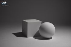 a white object sitting on top of a table next to a square and cube shaped object