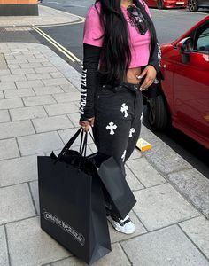 a woman with long black hair carrying shopping bags