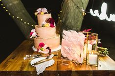 a table topped with a cake next to a candle