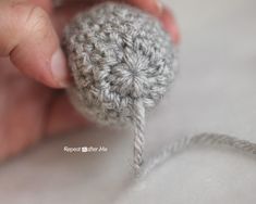 someone is crocheting a ball of yarn