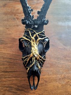 a black and gold spider sculpture sitting on top of a wooden table