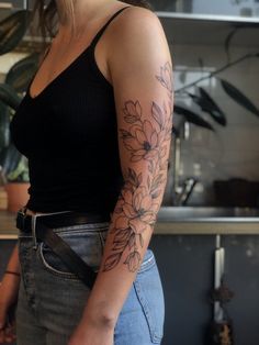 a woman with a flower tattoo on her arm