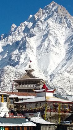 the mountains are covered with snow and buildings