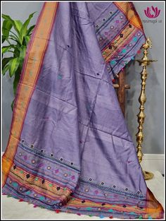 Beautiful Hand embroided Lambani Dupatta in purple Vidharba Tussar with solid orange border. The small floral embroided designs and colorful tassels at the end enhances the beauty of the dupatta more. Please note: Color may vary slightly from the picture. Thread pulls, knots and few thread gaps are common in this type of dupattas and is not a defect. Very minor stains from threads are normal for this type of hand embroided duand is not defect. Unstitched Purple Embroidered Fabric With Dupatta, Unstitched Purple Embroidered Traditional Wear, Purple Embroidered Fabric For Navratri In Traditional Drape, Navratri Purple Embroidered Traditional Drape, Purple Embroidered Fabric For Navratri, Purple Embroidered Fabric With Pallu In Traditional Drape, Purple Zari Work Embroidered Fabric For Navratri, Navratri Purple Zari Work Embroidered Fabric, Purple Embroidered Fabric With Zari Work For Navratri