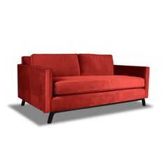 a red couch sitting on top of a white floor