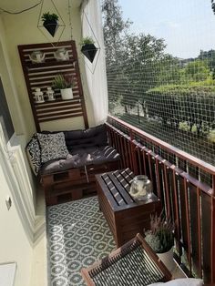 a balcony with chairs, tables and plants on the railings next to an open door