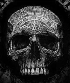 a black and white photo of a skull with an intricate design on it's face