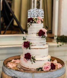 a three tiered cake with flowers on top