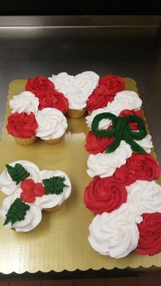 cupcakes decorated with red, white and green icing are on a tray