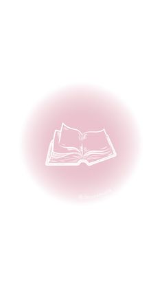 an open book sitting on top of a white table next to a pink light bulb