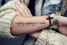 a woman with a cross tattoo on her arm that says, anything happens for a reason