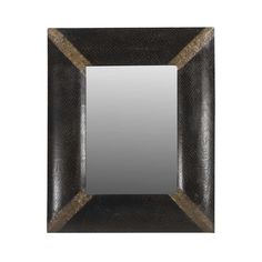 a mirror that is sitting on top of a white wall with a brown border around it