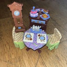 some toys are sitting on the floor next to each other and one has a clock