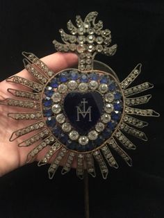 a brooch that is in someones hand