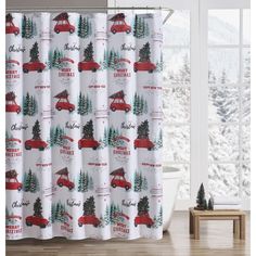 the shower curtain is decorated with christmas trees and red truck on it's side