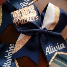 Navy and gold swish design cheer bow. Truckers cheer bow. Name on tail. Pastors Wife Appreciation, Cheer Bows Diy, Softball Hair Bows, Competition Bows, Sideline Cheer, Dance Bows, Competition Cheer, Logo Message, Softball Hair