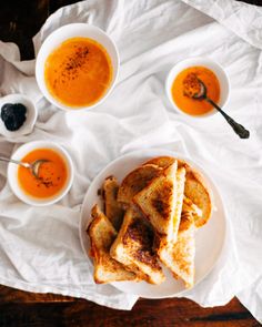 toasted sandwiches and bowls of soup on a table