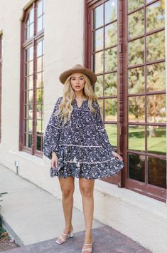 Floral Bohemian Dreamer! The Alana Dress has us all in our feelings. The Tiered Mini Dress features long balloon sleeves, tassel ties and a pretty floral print. Style the babydoll mini dress with heels for a day out with your girls or with sneakers for a more casual look. Black and white Floral print Split neckline Knee Length Tassel ties Tiered ruffle babydoll silhouette Contrast white piping trim Balloon peasant sleeves with elastic cuffs Smocked shoulder detail Relaxed Fit (Loose Fit) 100% Po Casual Floral Print Dress With Balloon Sleeves, Spring Tassel Mini Dress, Bohemian Summer Dress With Balloon Sleeves, Spring Mini Dress With Tassels, Spring Mini Dress With Balloon Sleeves, Spring Day Out Dress With Tassels, Flowy Spring Dress With Tassels, Spring Long Sleeve Dresses With Tassel Ties, Spring Boho Dress With Tassels