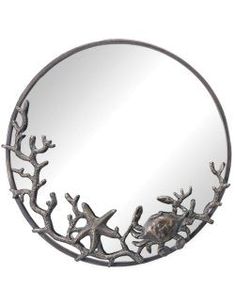 a round mirror with branches and starfishs on the bottom, hanging from a wall