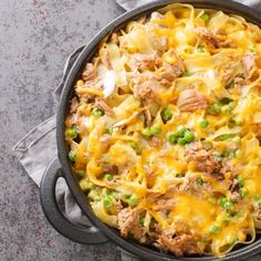 a casserole dish with meat, peas and cheese