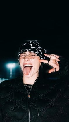 a man with glasses and a bandana making a silly face