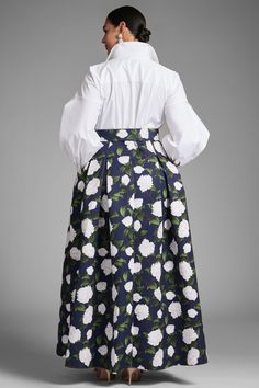 Florence is classic versatility at it's finest. Her top features a pearled button down silhouette in Indian cotton while the bottom is a navy, subtly pleated ball skirt with ivory printed peonies. The two are met in the middle with a printed belt for a flattering, waist-cinching look.Details:Model is 5'10" wearing size 2Full-Length, 60" from top of shoulder to bottom hemFront Button Closure Indian Cotton - Printed Poly Faille 100% PolyesterImportedStyle #S242G18-416 Elegant Floral Print Skirt For Formal Occasions, Elegant Formal Skirt With Floral Print, Elegant Fitted Skirt For Garden Party, Elegant Formal Floral Print Skirt, Elegant Floral Print Skirt For Daywear, Elegant Voluminous Skirt For Garden Party, Elegant Floral Print Voluminous Skirt, Elegant Voluminous Floral Print Skirt, Elegant Full Skirt For Garden Party