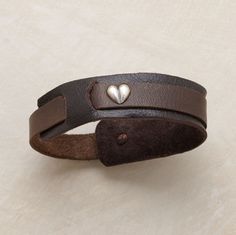 a leather bracelet with two hearts on it