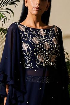 Midnight blue long kurta with floral embroidered detail and flared sleeves. Comes with flared skirt.
Components: 2
Fabric: Pure Georgette, Satin Lining, Cotton Silk
Neckline: Boat
Sleeve Length: Three quarter 
Color: Blue
Embroidered
Embroidered  skirt - Aza Fashions Long Kurta, Embroidered Skirt, Fashion App, Flared Skirt, Set For Women, Flared Sleeves, Cotton Silk, Aza Fashion, Flare Skirt