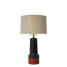 a black and brown table lamp with a beige shade