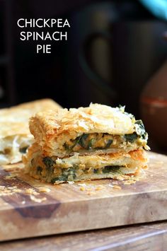 a close up of food on a cutting board near a knife and bowl with the words chickpea spinach pie