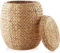 a large woven basket next to a small round container on a white background with reflection