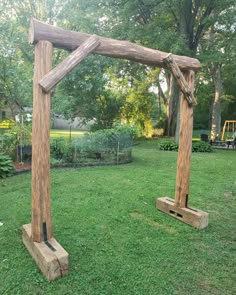 two wooden structures sitting on top of a lush green field