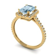 a gold ring with an aqua blue topazte and white diamonds on the sides